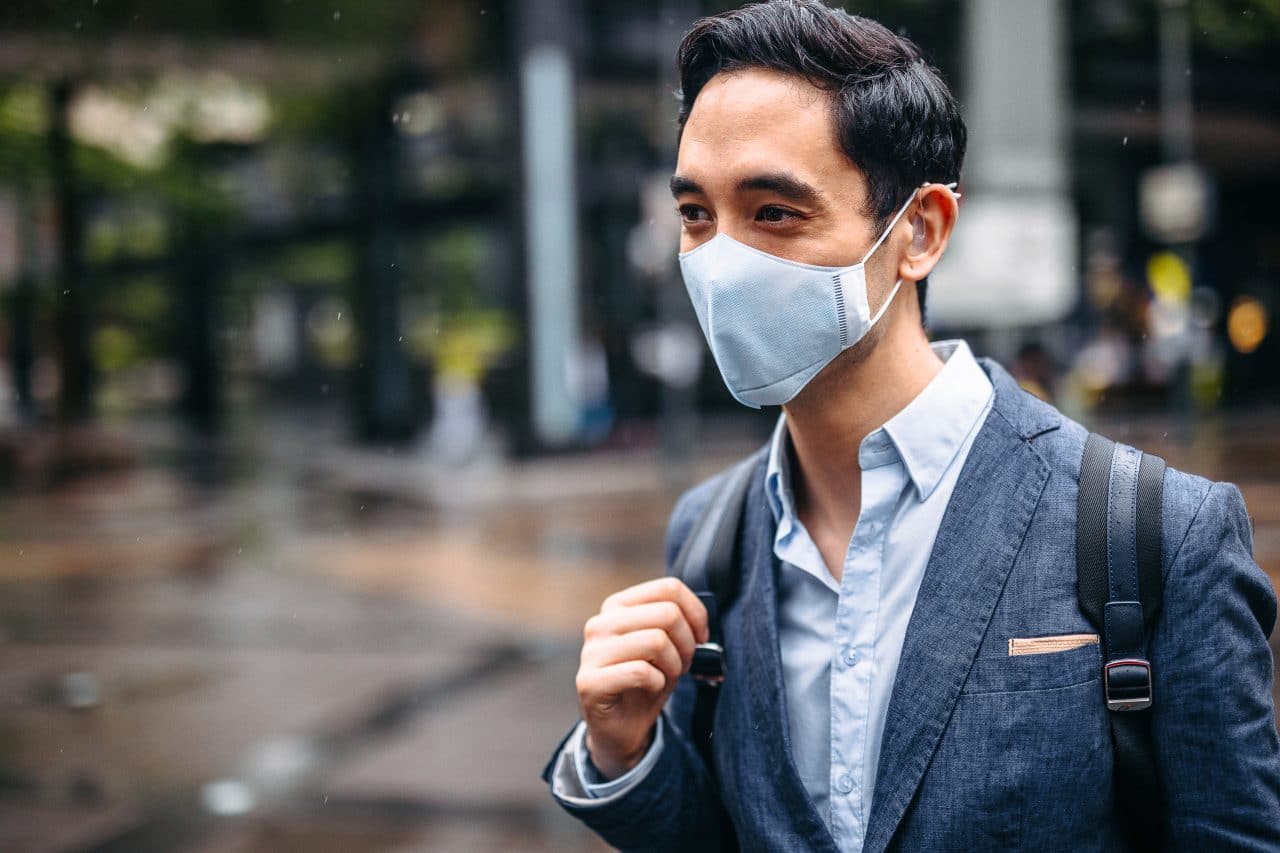 Man with a hearing aid wearing a mask.