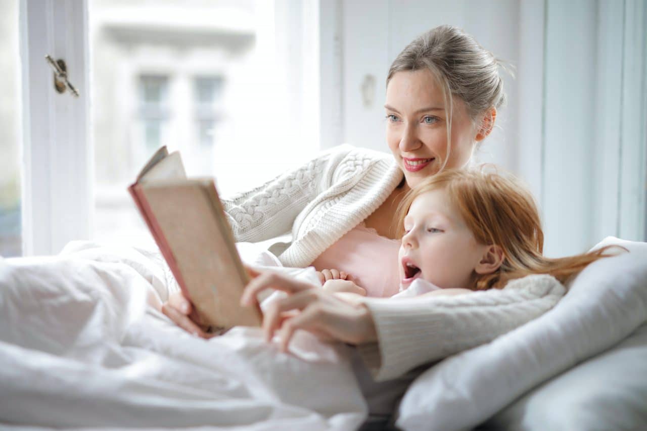 Mother reading a story with her daughter.