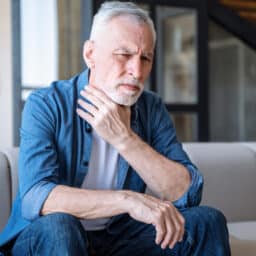 Man holding his throat after losing his voice