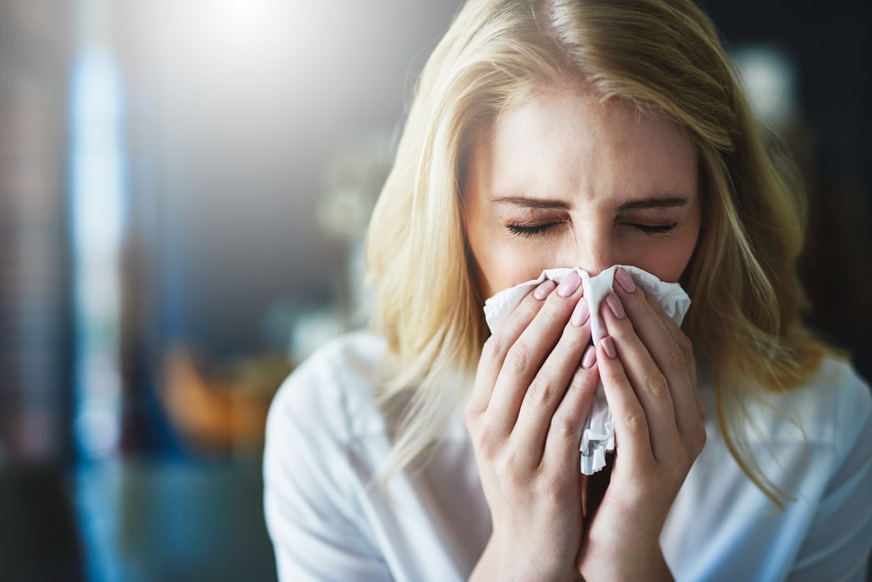 Woman blows nose