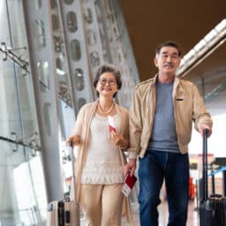 Happy couple walking together in an airport terminal