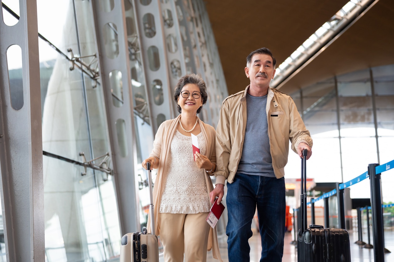 Happy couple walking together in an airport terminal.